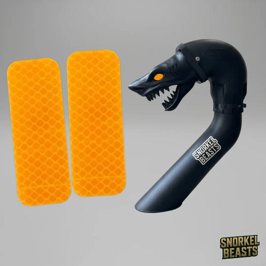 Black snorkel with shark design and orange reflectors on a gray background, featuring the Snorkel Beasts brand.